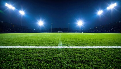 Obraz premium A vibrant football field illuminated at night, showcasing bright floodlights and lush green grass, ready for action and spectators