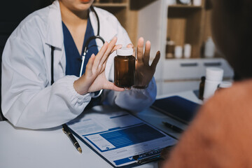 Specialized doctor is explaining taking medicine to a patient. Health and medicine consultation.