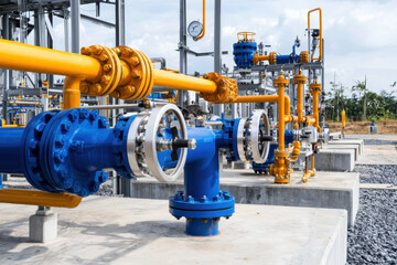 Fototapeta premium Industrial pipeline system with blue and yellow valves, showcasing energy infrastructure and engineering design