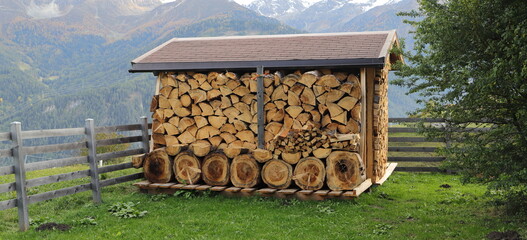 a wooden shelf full of firewood