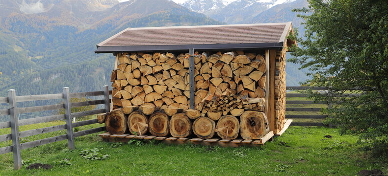 a wooden shelf full of firewood