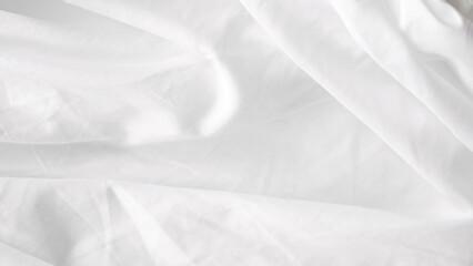 Smooth white bedsheet background in a serene and calming bedroom setting