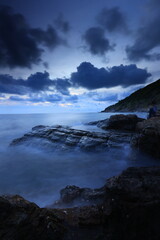 Obraz premium Khao Laem Ya is a cape formed by sedimentary rocks that accumulate in the deep sea. and transformed by the process of mountain formation. Khao Laem Ya–Mu Ko Samet National Park, Rayong, THAILAND