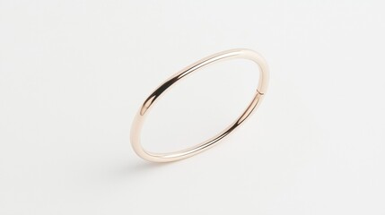 A shiny gold bracelet with a simple, elegant design.