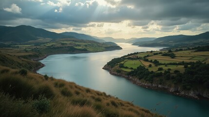 Overhead view of Urdaibai Estuary under cloudy skies, revealing winding waterways and lush wetlands.