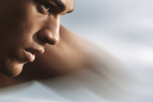 dynamic portrait of javelin thrower captured in motion on left side of frame - Powered by Adobe