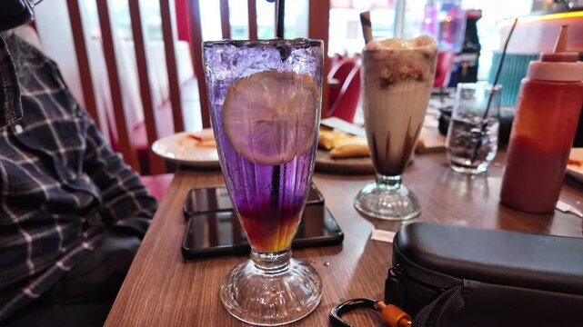 Stirring Butterfly pea flower drink with lime , honey and mint leaf , fresh herbal healthy detox drink