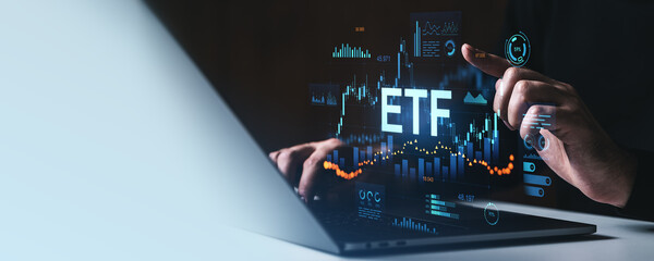 Digital interface showing ETF trading data on laptop screen in dark setting.