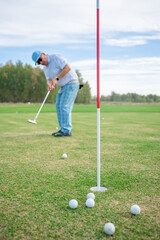 A dedicated golfer is practicing their short game skillfully on the beautiful course