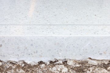 Terrazzo floor both top and side vertical surface at border. Clean white bright and shiny surface with small gravel texture. Interior design in house building. Empty space suit for background.