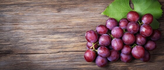 Cluster of red grapes on rustic wooden surface