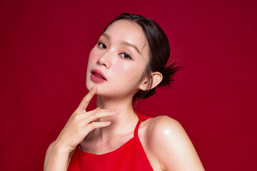 赤い背景で撮影をした若い女性のアジアンビューティーイメージ