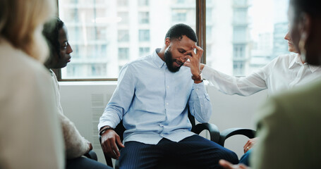 Sad man, meeting and support group with team at office for rehabilitation, empathy or care. Male...