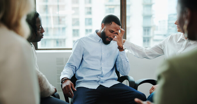 Sad man, meeting and support group with team at office for rehabilitation, empathy or care. Male person, employee or emotional with community for understanding, sympathy or safe space at workplace
