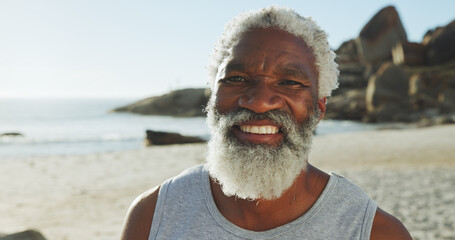 Beach, senior black man and travel in portrait for holiday, peace and happiness with confidence. Ocean, male person and outdoor with smile for adventure, vacation and tourist for exploration in sea