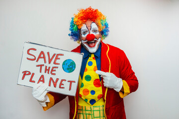 Clown proudly holding a protest sign to save the planet