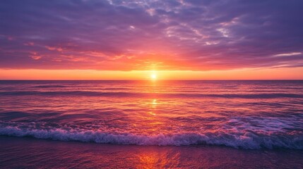 Obraz premium Stunning sunset over ocean waves, vibrant colors fill the sky and water, creating a peaceful atmosphere at dusk.