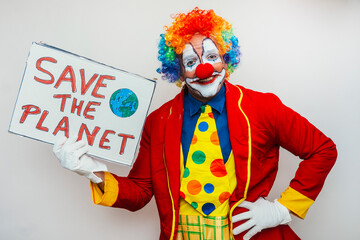 Clown holding save the planet sign