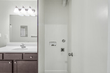 Bright modern bathroom interior with white bathtub, single sink vanity, and granite countertop. Perfect for real estate, interior design, and home improvement concepts.