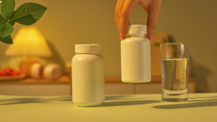 Two different sized medicine bottles were placed on the desk, the smaller one being lifted off the desk by the user. Next to it was a glass of purified water for the patient to take the medicine.