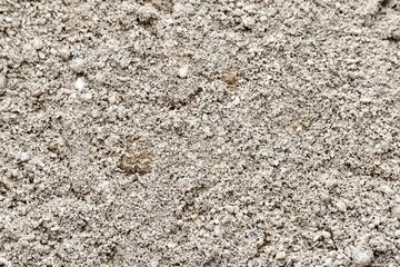 Close up fine construction sand pile texture isolated on horizontal full frame background.