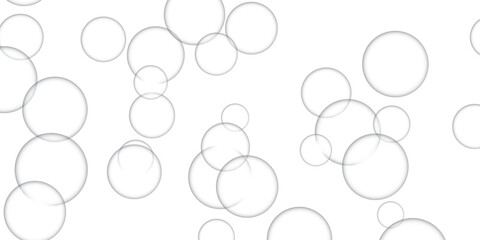 Floating transparent soap bubbles of varying sizes against a clean white backdrop perfect for playful designs and illustrations.