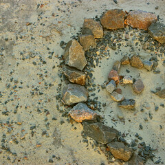 Rocky Sand with Stones Laid Out in Curved Line with Copy Space at a Side of Image