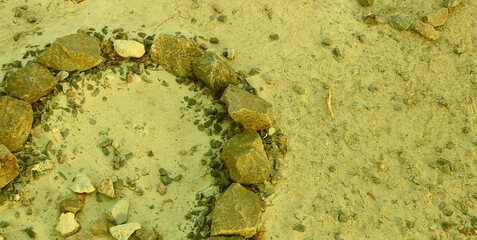 Circle Made with Rocks on Desert Soil Textured Background