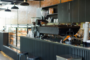 View of counter bar architecture modern bakery with coffee shop and cafe industrial style, decorated with brick wall, loft in dark wood and black steel furniture background, Interior design concept.