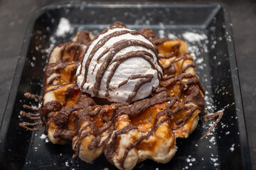 Baked belgian sugar waffles with various toppings, delicious sweet street food in Bruges, Flanders, Belgium