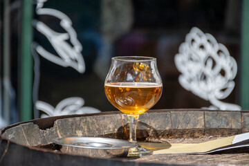 Belgian beer in glass in old brewery in Bruges, strong triple, tasty beverage, lunch with beer, tourist destination, Flanders, Belgium