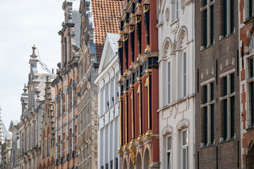 Medieval houses facades and rooftops and city tower with bells in the centre of Bruges, Flanders