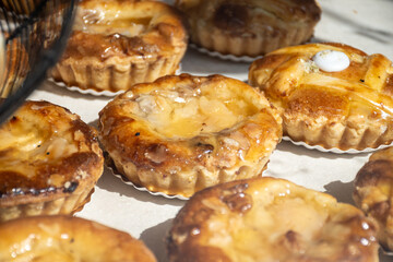 Fresh baked buttered fruit and sweet buns, cakes, pastries in artisan bakery early morning in Bruges, Belgium