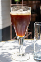 Belgian beer in glass in old brewery in Bruges, dubbel dark, tasty beverage, lunch with beer, tourist destination, Flanders, Belgium