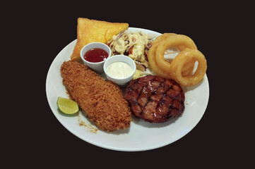 Steak combo with salad and onion ring ondark background.