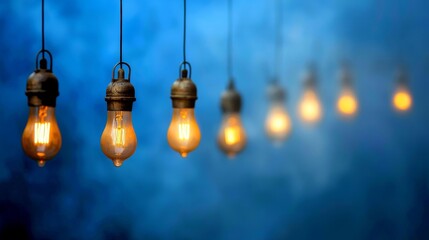 Vintage Light Bulbs Hanging Against a Soft Blue Background with a Dreamy Atmosphere
