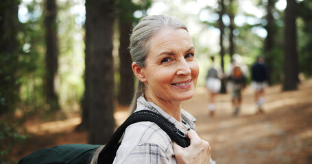 Hiking, nature and portrait of mature woman with backpack for exercise, workout and walking for wellness. Fitness, travel and person in forest and woods for trekking, adventure and journey outdoor