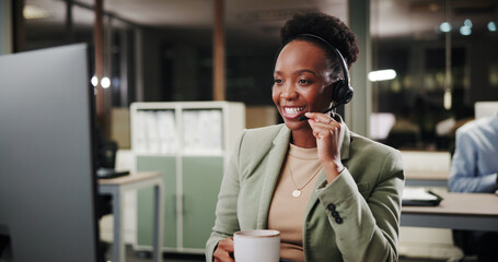 Call center, coffee and happy woman in office for customer service, listening or crm at night. Contact us, telemarketing or African sales agent with drink with headset for help or faq on computer