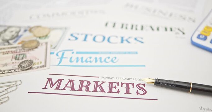 Financial markets, investments, and economic news : Currency notes, coins, and a pen placed on papers, symbolizing financial transactions, investments, currency, business, and stock market analysis.