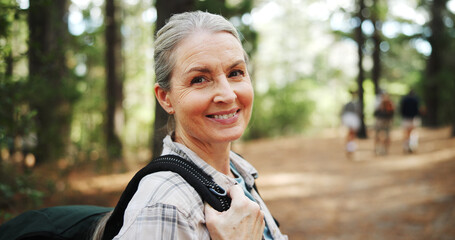 Hiking, forest and portrait of mature woman in nature with backpack for exercise, walking and health. Fitness, travel and person in woods for trekking, adventure and journey outdoor for wellness
