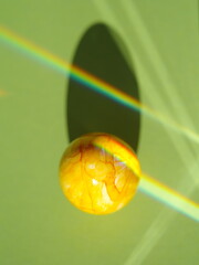 A yellow ball with a shadow on it