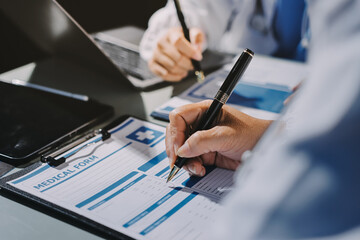 Male and female doctors are having a meeting in a hospital room.