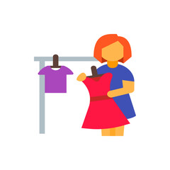 Woman with orange hair holding a red dress next to a purple shirt hanging on a clothing rack stand