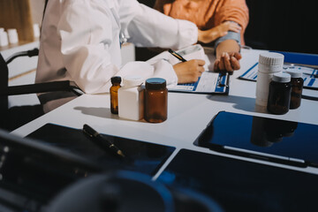 Nurse measuring blood pressure of elderly woman at table, closeup. Assisting senior generation