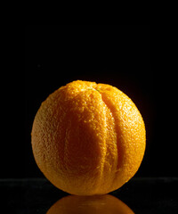 orange fruit on black background