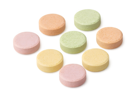 Colorful round tablets arranged in a circular pattern, showcasing various pastel shades like pink, green, yellow, and orange. Concept Colorful Tablets, Pastel Shades, Circular Arrangement