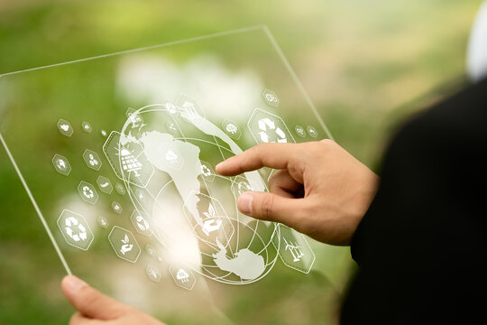 Businessman typing on computer doing field analysis with virtual icons about environment, analysis, investment, green business etc.