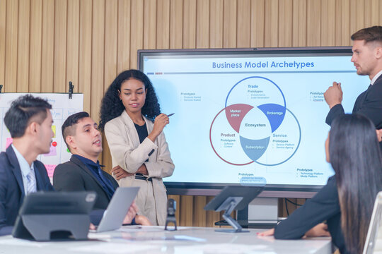 business meeting or seminar,happy multiracial business team conference,presentation with statistic report ,brainstorming in office room