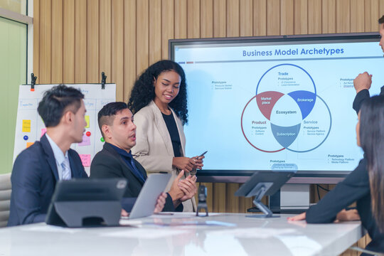 business meeting or seminar,happy multiracial business team conference,presentation with statistic report ,brainstorming in office room