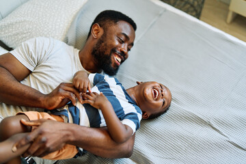 father child son fun family man boy happy together happiness smiling cheerful togetherness day bonding parent love playing young joy
